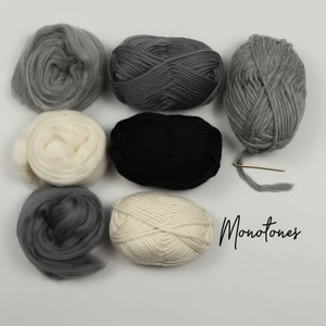 May include: A collection of six skeins of yarn in various shades of gray, white, and black. The yarn is arranged in a circle on a white surface. The word "Monotones" is written in black cursive below the yarn.