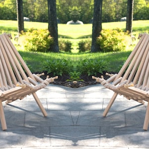 Pu&ograve; includere: Due sedie pieghevoli in legno con dettagli in corda posizionate su un patio. Le sedie sono in legno naturale e hanno un design semplice e rustico.