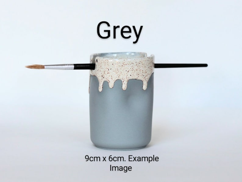 May include: Grey ceramic brush holder with a white speckled glaze and a drip effect. The holder is 9 cm x 6 cm. Example Image.