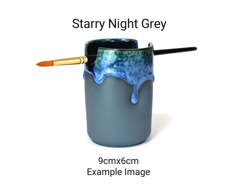 May include: A gray ceramic brush holder with a blue and green glaze. The glaze has a drip effect. The holder is 9cm x 6cm.  Starry Night Grey.