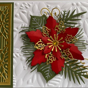 May include: A Christmas card with a red poinsettia flower, gold accents, and green foliage on a white background.