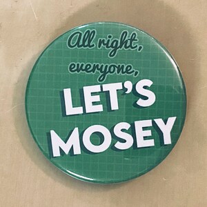 May include: Green button with white text that reads "All right, everyone, LET'S MOSEY". The button has a grid pattern.