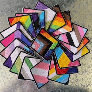 May include: A set of 15 colorful fabric patches, each featuring a different geometric design. The patches are arranged in a circular pattern, with the center patch being a rainbow design. The patches are all made of a soft, durable fabric and are perfect for adding a touch of personality to any project.