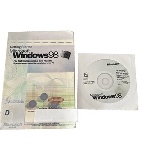 May include: A Microsoft Windows 98 software package including a Getting Started manual with a white and light blue cover and a circular installation disc in a white paper sleeve. Both items feature the Microsoft Windows 98 logo and text.