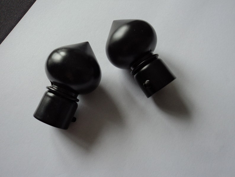 A pair of French vintage black metal curtain pole finials for a A pair of French vintage black metal curtain pole finials for a