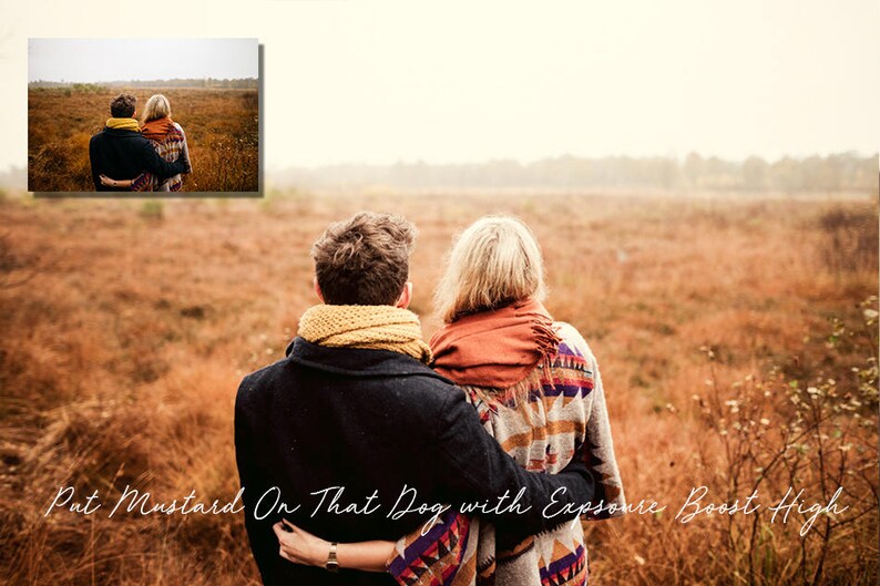 May include: A couple wearing scarves and jackets stand in a field of tall grass, looking out at the horizon. The grass is a mix of brown and green, and the sky is a light blue.
