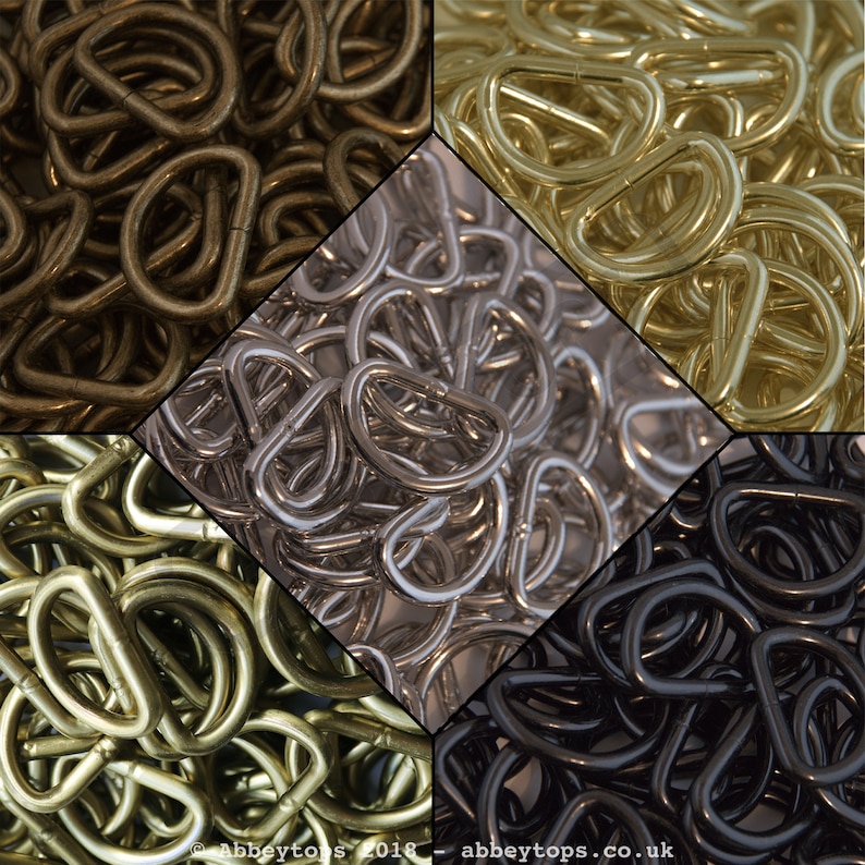 May include: A close-up image of four piles of metal D-rings. The piles are arranged in a square shape. The D-rings are in four different finishes: antique brass, nickel, brass, and black.