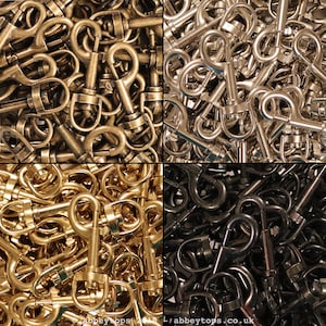 May include: A close-up image of a large quantity of metal swivel clasps. The clasps are shown in four different finishes: gold, silver, black, and brass.