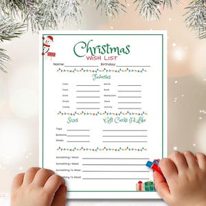 May include: A Christmas wish list on white paper with green and red accents. The top of the list has the words "Christmas Wish List" in green script. The list includes sections for favorites, sizes, and gift cards.