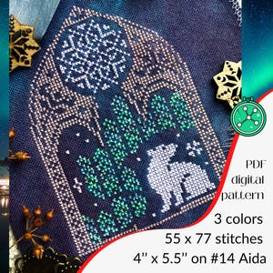 May include: Cross-stitch pattern featuring a winter scene with a white animal, green trees, and a snowflake design. The pattern is 4" x 5.5" on #14 Aida, with 55 x 77 stitches and uses 3 colors. The design is set against a dark blue background.