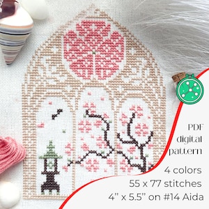 May include: Cross-stitch pattern with a floral design, pink blossoms, and a Japanese lantern. The pattern is 10.16 cm by 13.97 cm and uses 4 colours. The design is on #14 Aida cloth.