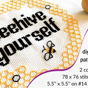 May include: A cross-stitch pattern featuring the text "beehive yourself" in black on a white background. The pattern is surrounded by a yellow honeycomb design and includes a small bee illustration. The pattern is 78 x 76 stitches and measures 5.5 inches by 5.5 inches on 14 count Aida cloth.