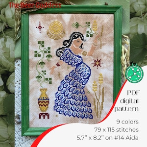 May include: A cross-stitch pattern featuring a woman in a blue dress holding a sprig of wheat. The pattern is titled "The Beer Goddess" and includes 9 colors, 79 x 115 stitches, and is designed for 14 count Aida fabric.