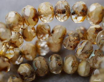 May include: A strand of brown and clear glass beads with a faceted, irregular shape. The beads have a mottled, marbled appearance.