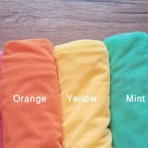 May include: New colors! A row of eight fabric swatches in different colors: coral, pink, orange, yellow, mint, turquoise, pale blue.