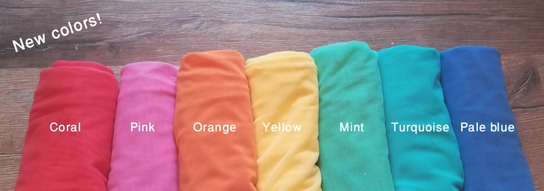May include: New colors! A row of eight fabric swatches in different colors: coral, pink, orange, yellow, mint, turquoise, pale blue.