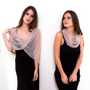 May include: Four-panel image of a woman wearing a black dress and a sheer, taupe-colored shawl. The shawl drapes over the shoulders and arms. The woman is posed in different positions against a white background.
