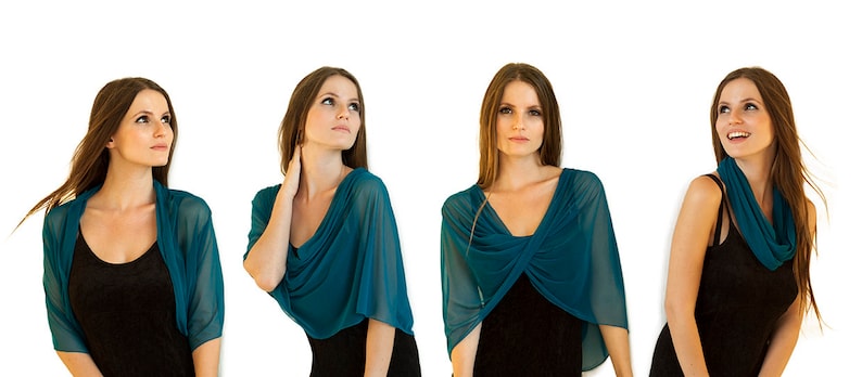 May include: Four women wearing teal blue sheer scarves in different styles. The scarves are draped over their shoulders and necks, and they are all wearing black tops underneath.