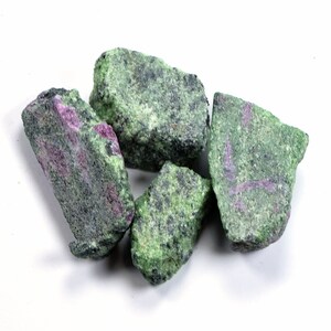 May include: Five rough, green and pink stones with a mottled appearance. The stones are irregularly shaped and have a natural, unpolished finish.