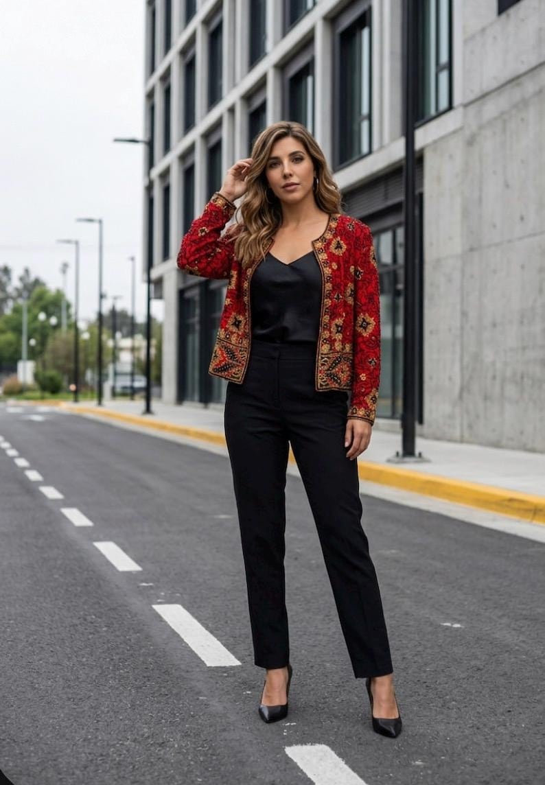 May include: A red jacket with gold and black embroidery, paired with a black top and pants. The jacket features an intricate floral design. The outfit is completed with black heels. The ensemble is suitable for formal or semi-formal occasions.