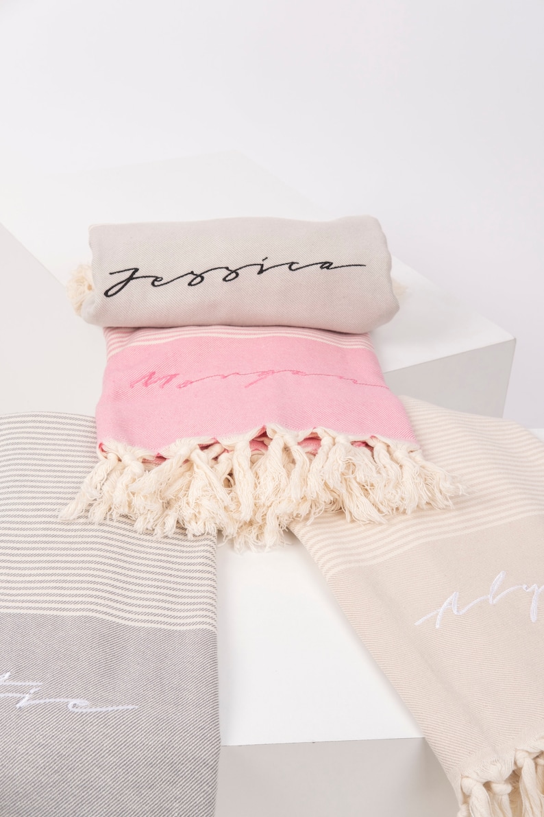 May include: Three striped towels with fringe, each with a different name embroidered on them. The names are "Jessica", "Mary", and "Abby".