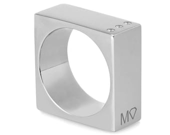 May include: A silver square ring with three small diamonds set into the top. The ring is engraved with the letters "M" and "O" and a diamond symbol.