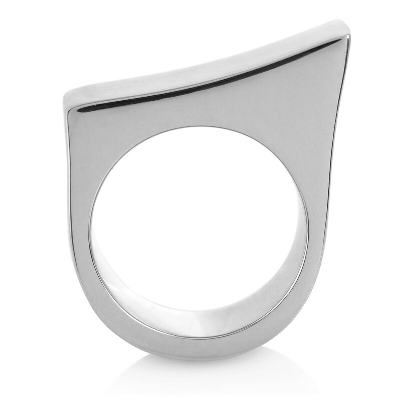 May include: A silver ring with a unique, angular design. The ring is made of a smooth, polished metal and has a simple, modern aesthetic.