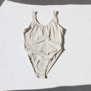 May include: A set of three ceramic mugs with a speckled, cream-colored glaze. Each mug features a different hand-painted floral design in shades of blue, green, and yellow. The mugs have a simple, rounded shape and a comfortable handle.