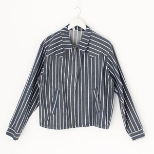 May include: A blue and white striped jacket with a zip fastening. The jacket has long sleeves and a collared neckline.