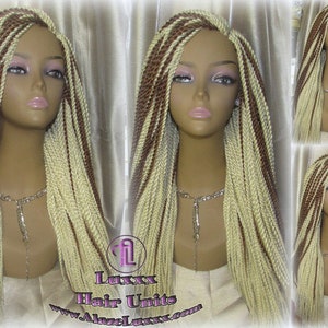 May include: A long blonde and brown braided wig. The wig is styled in a straight, even pattern. The wig is on a mannequin head.