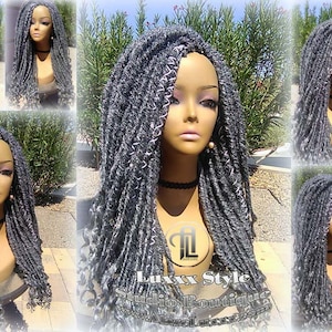 May include: A gray and white long, curly, synthetic dreadlock wig on a mannequin head. The wig is styled with a part on the side. The mannequin is wearing a black choker necklace. The background is a blurred image of a patio with plants.