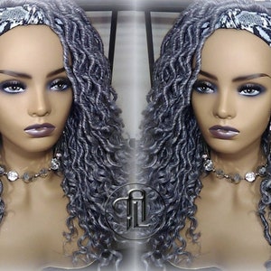 May include: A silver gray wig with loose curls, styled with a black and white patterned headband. The wig is on a mannequin head.
