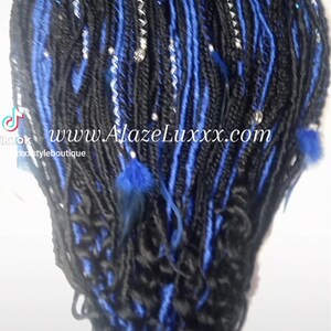 May include: Black and blue synthetic dreadlocks with silver and blue beads and blue feathers. www.AlazeLuxxx.com