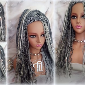 May include: A long, gray and white braided wig with silver accents. The wig is styled in a straight, flowing style.