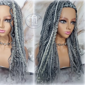 May include: A gray and white braided wig with a headband. The wig is long and straight, with a slight wave at the ends. The headband is black and white.