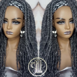 May include: Gray and black synthetic dreadlock wig with a black and white patterned headband. The wig is styled in long, loose dreadlocks.