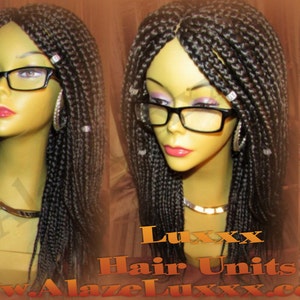 May include: A black braided wig with beads on a mannequin head. The wig is long and straight. The mannequin is wearing glasses. The text "Luxxx Hair Units www.AlazeLuxxx.com" is visible in the image.