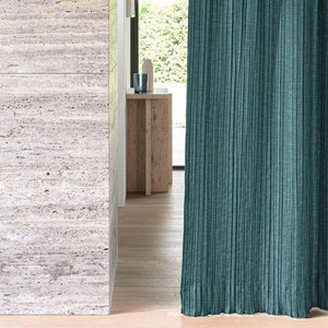 May include: Teal blue curtains with a textured woven fabric hanging in a modern interior design setting.