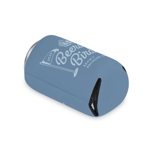 May include: A light blue can cooler with the text "Beer Bird" and "Kevin's Bachelor Party 2026" in white. The cooler has a black, open-ended design on one side.