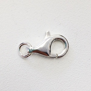 May include: Silver lobster clasp for jewelry making. The clasp is silver in color and has a shiny finish.