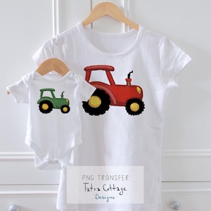 May include: A white t-shirt and baby onesie set with tractor designs. The adult t-shirt has a red tractor, the onesie a green one. Both tractors have black wheels with yellow centres. The set is displayed on wooden hangers.