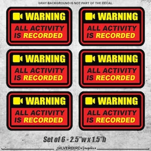 May include: Set of six 2.5 inch by 1.5 inch warning decals. Each decal features a red background with a black border and yellow text. The text reads "WARNING ALL ACTIVITY IS RECORDED" with a video camera icon.