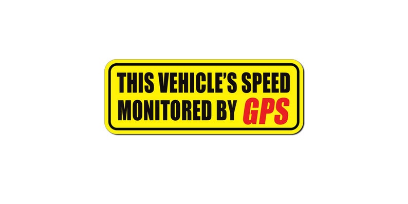 May include: A rectangular yellow sticker with black text that reads: "THIS VEHICLE'S SPEED MONITORED BY GPS." The word "GPS" is in red. The sticker has a black border and is against a white background.