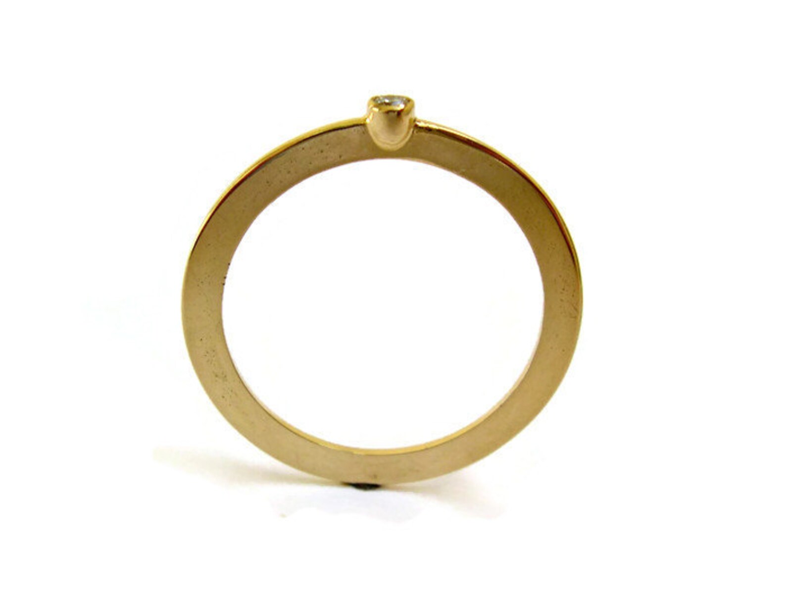 thin gold ring with tiny diamond