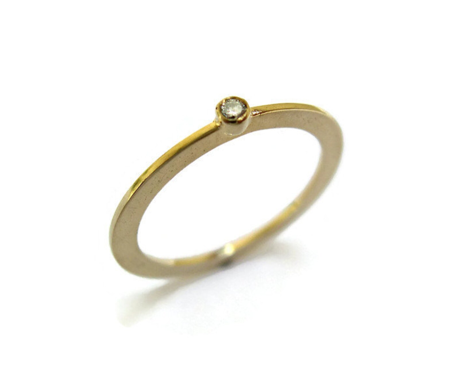 thin gold ring with tiny diamond