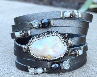 Metallic Gunmetal Gray Split Leather Cuff Bracelet with a Mother of Pearl Centerpiece Encrusted with Tiny Crystals.