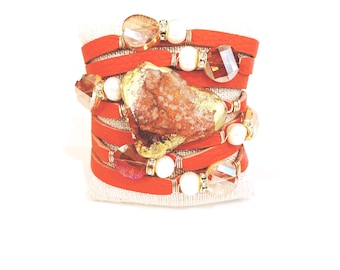 Sunset Orange Split Leather Cuff with a Large Jasper Center Stone, surrounded by a sprinkling of freshwater pearls and crystals.