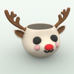 Puede incluir: Taza de cerámica blanca con forma de reno con cuernos marrones, ojos negros, mejillas rosadas y nariz roja.