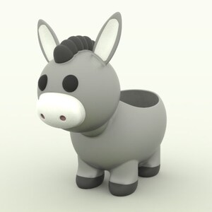 Pode incluir: Um vaso de planta com formato de burro cinza com olhos pretos e uma crina preta. O vaso tem um corpo redondo e quatro pernas.