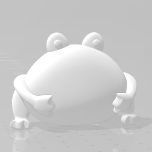May include: A white, cartoon-style frog figurine with large eyes and a rounded body. The frog is sitting on a white surface.